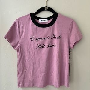 DAYDREAMER CORPORATE ROCK STILL SUCKS SHRUNKEN TEE IN LOTUS FLOWER S